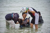 Dr. Keiichi Ueda, Charumi Aquarium veterinarian, administers an IV to an injured dwarf sperm whale April 17, 2017, at Kadena Marina, Japan. The veterinarian team had to administer aid to the whale before it could be transported for recovery. (U.S. Air Force photo by Senior Airman Omari Bernard/Released)
