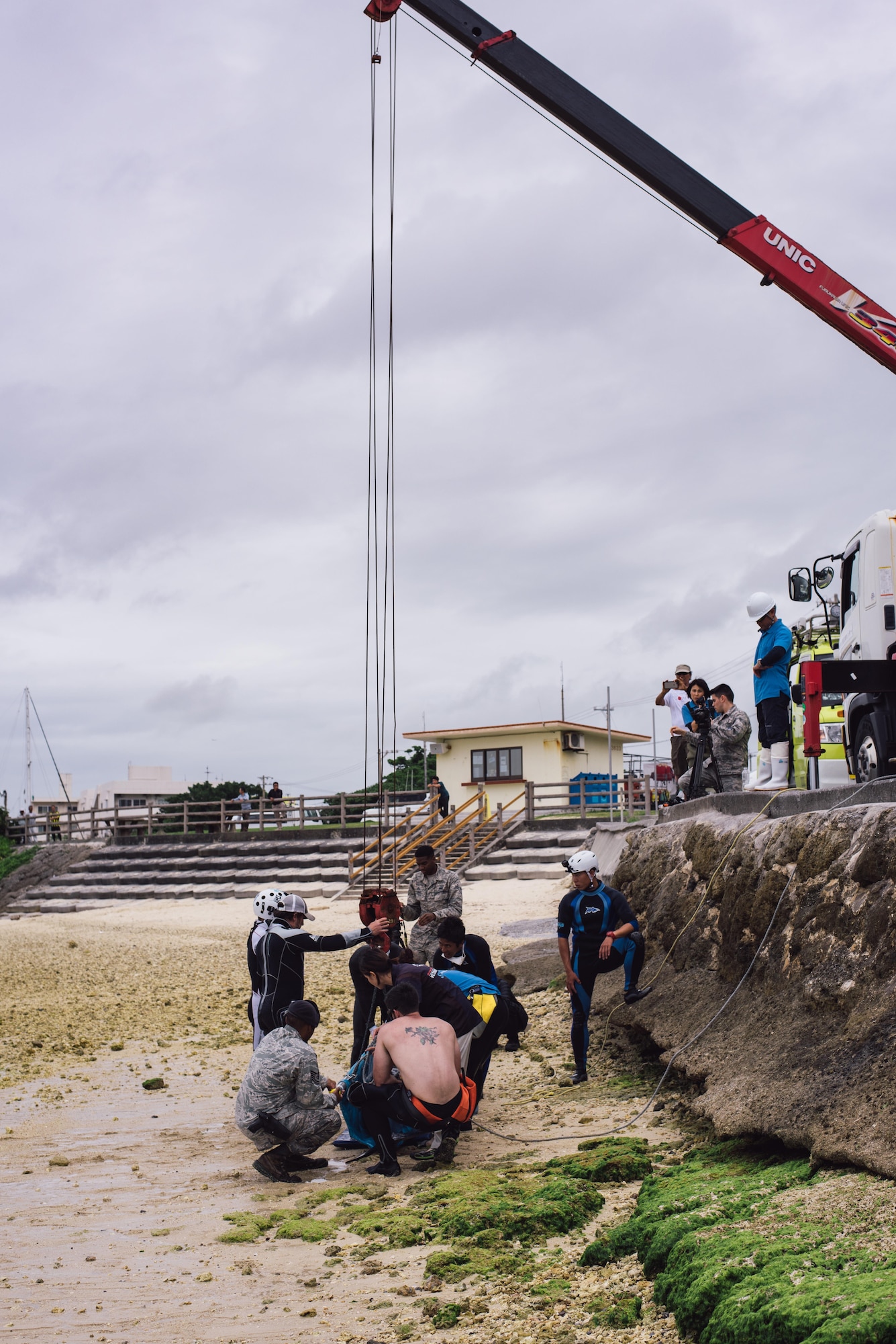 A makeshift rescue team of Okinawan veterinarians, and personnel from the 18th Security Forces Squadron and 18th Force Support Squadron secure an injured dwarf sperm whale to a crane April 17, 2017, at Kadena Marina, Japan. The team worked together to transport the whale to the Charumi Aquarium for medical care. (U.S. Air Force photo by Senior Airman Omari Bernard/Released)