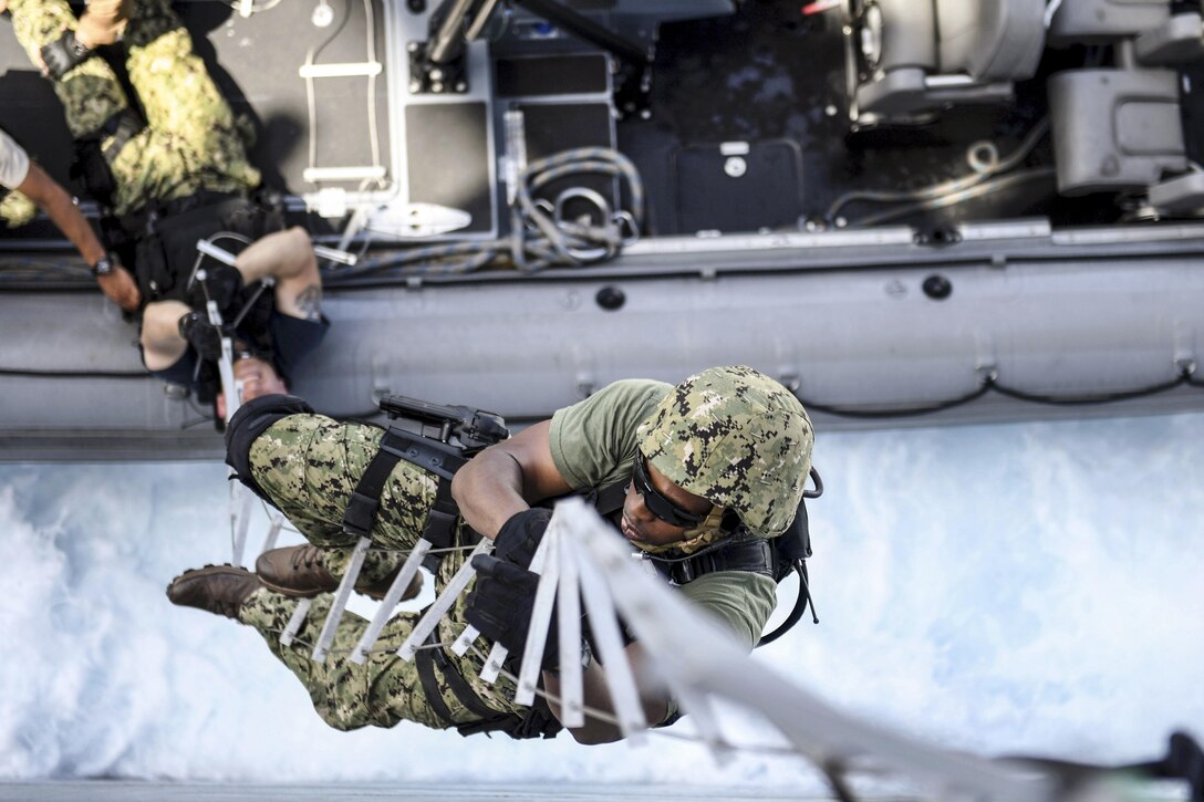 Navy Petty Officer 2nd Class Patrick W. Holmes climbs a hook ladder while boarding the USS Carter Hall during Alligator Dagger 17 in the Gulf of Aden, April 12, 2017. The exercise provides an opportunity to enhance multilateral capabilities in critical mission sets inherent to the Navy and Marine Corps. Navy photo by Petty Officer 1st Class Darren M. Moore