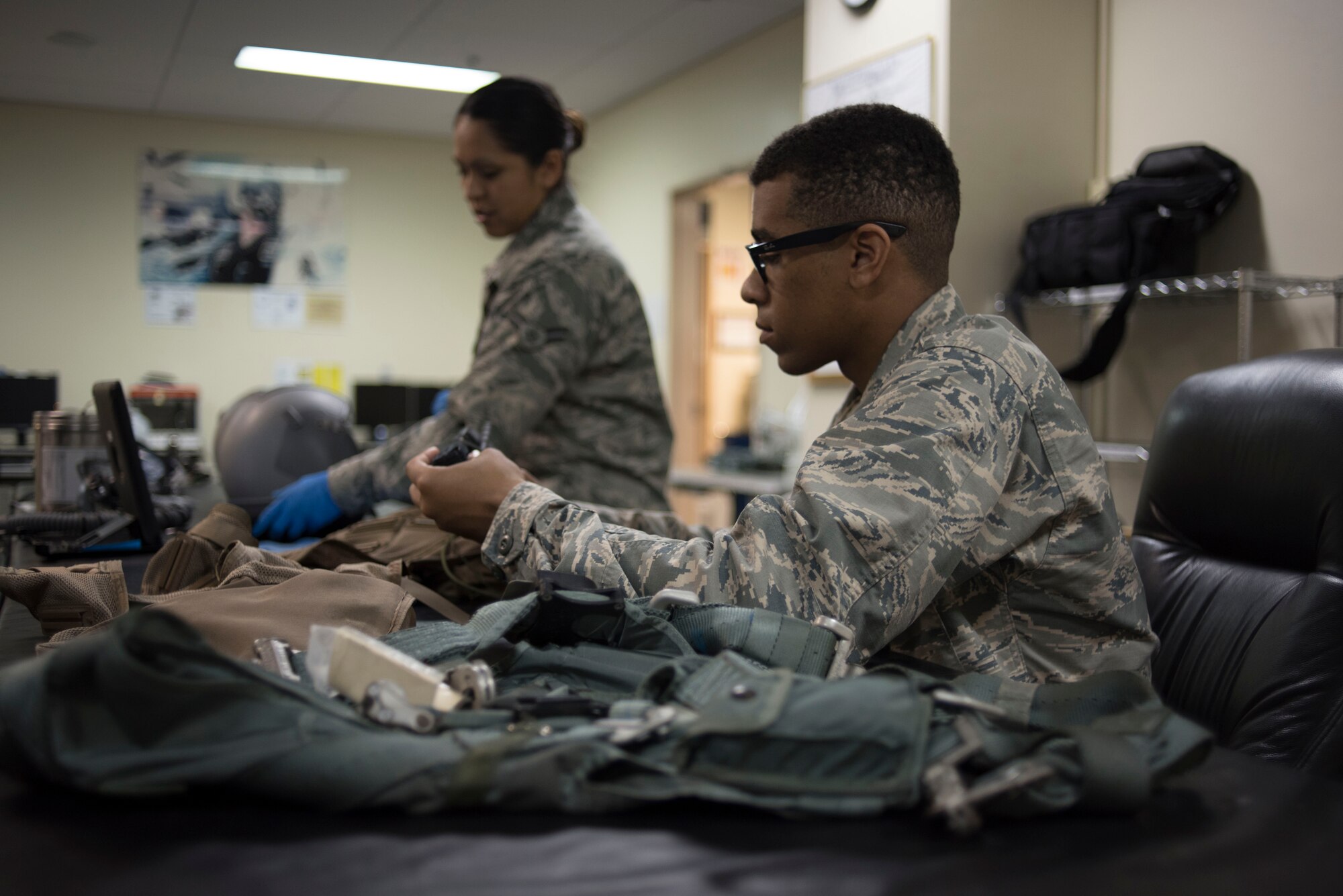 U.S. Air Force Airman Nigel Simpson, 18th Operations Support Squadron aircrew flight equipment technician assigned to the 44th Fighter Squadron, services a survival vest April 18, 2017, at Kadena Air Base, Japan. The AFE shop oversees pilots' item serviceability and restocks their uniform with supplies like water and food if needed. (U.S. Air Force photo by Senior Airman John Linzmeier)