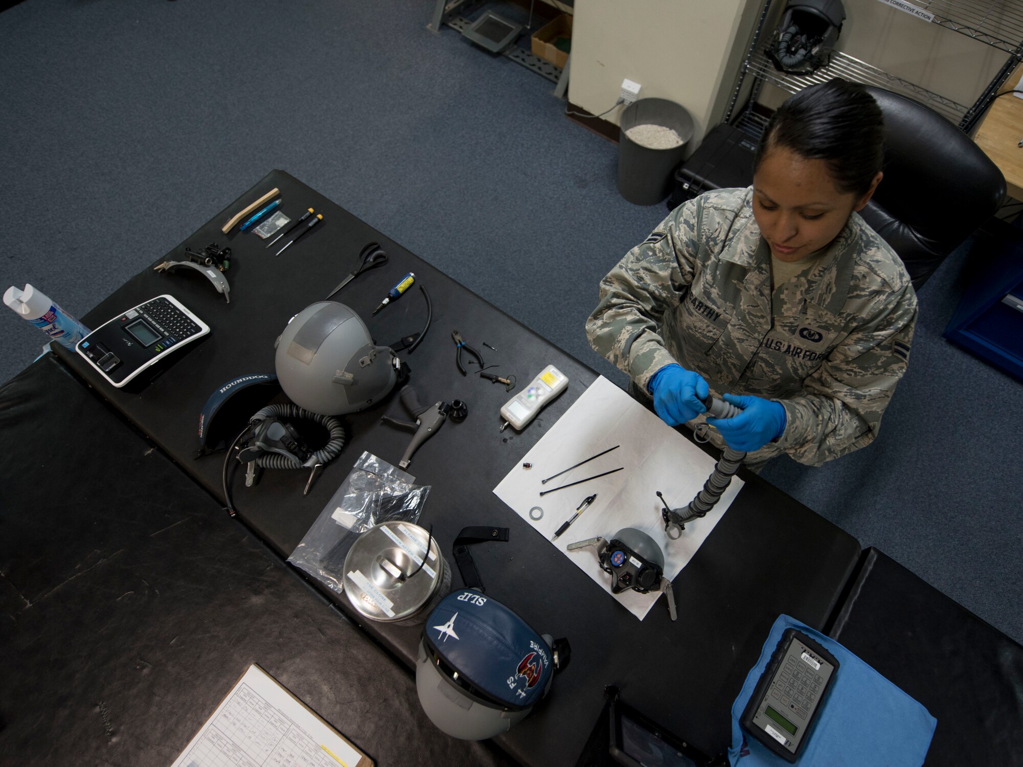 U.S. Air Force Airman 1st Class Denise McCarthy, 18th Operations Support Squadron aircrew flight equipment technician assigned to the 44th Fighter Squadron, reassembles a flight helmet April 18, 2017, at Kadena Air Base, Japan. Aircrew flight equipment is routinely broken down and put back together in order to ensure all components function properly. (U.S. Air Force photo by Senior Airman John Linzmeier)
