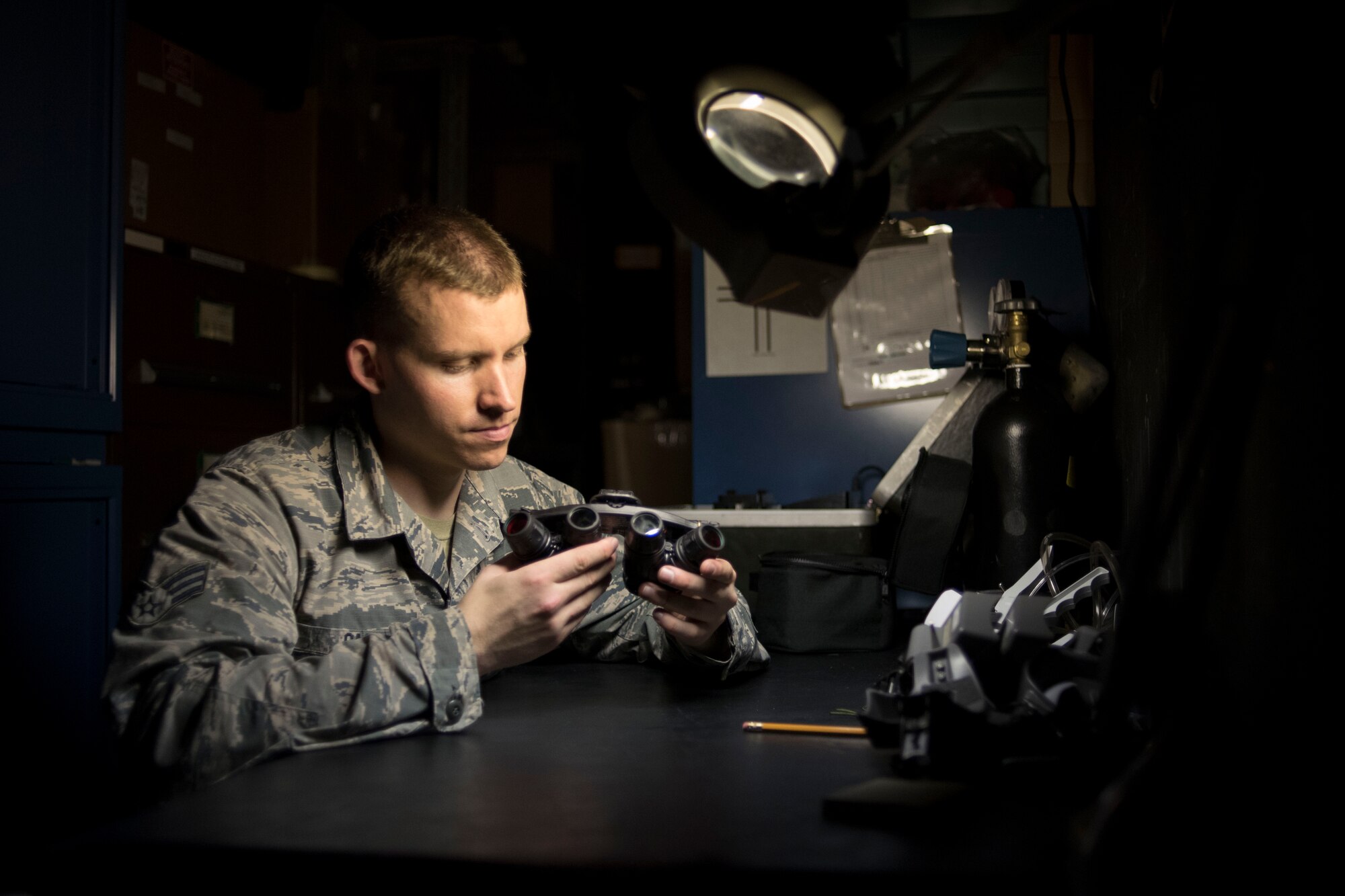 U.S. Air Force Senior Airman Joseph Gago, 18th Operations Support Squadron aircrew flight equipment technician assigned to the 44th Fighter Squadron, inspects night vision goggles April 18, 2017, at Kadena Air Base, Japan. Aircrew flight equipment Airmen work day-and-night to inspect, repair and modify helmets, night vision goggles, life rafts and chemical gear among many other things to keep aircrews safe and able to complete the mission at hand. (U.S. Air Force photo by Senior Airman John Linzmeier)