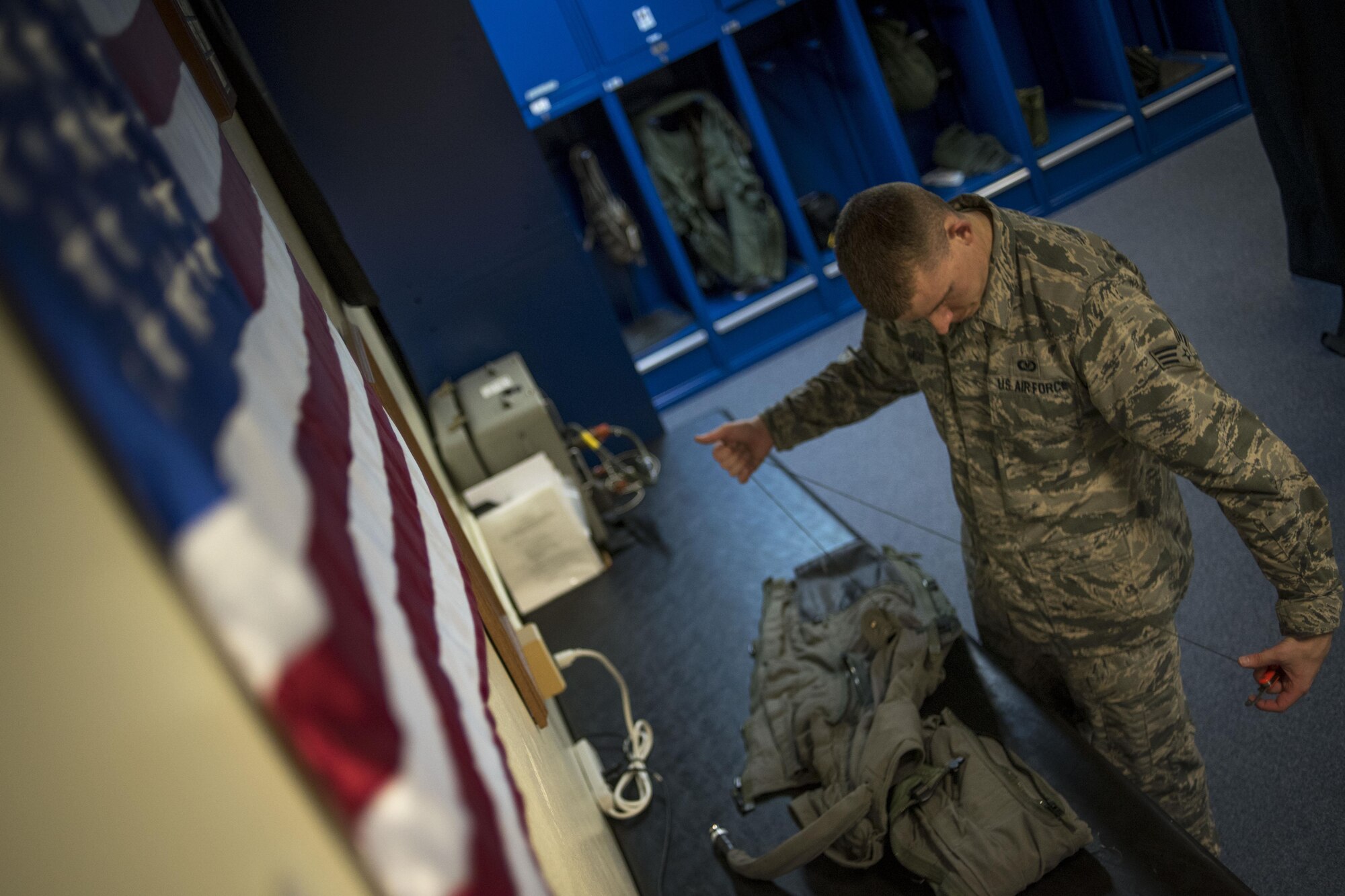 U.S. Air Force Senior Airman Joseph Gago, 18th Operations Support Squadron aircrew flight equipment technician assigned to the 44th Fighter Squadron, inspects a G-suit April 18, 2017, at Kadena Air Base, Japan. The AFE team's mission is to support flight operations by ensuring pilots have reliable equipment in the event of an egress situation. (U.S. Air Force photo by Senior Airman John Linzmeier)