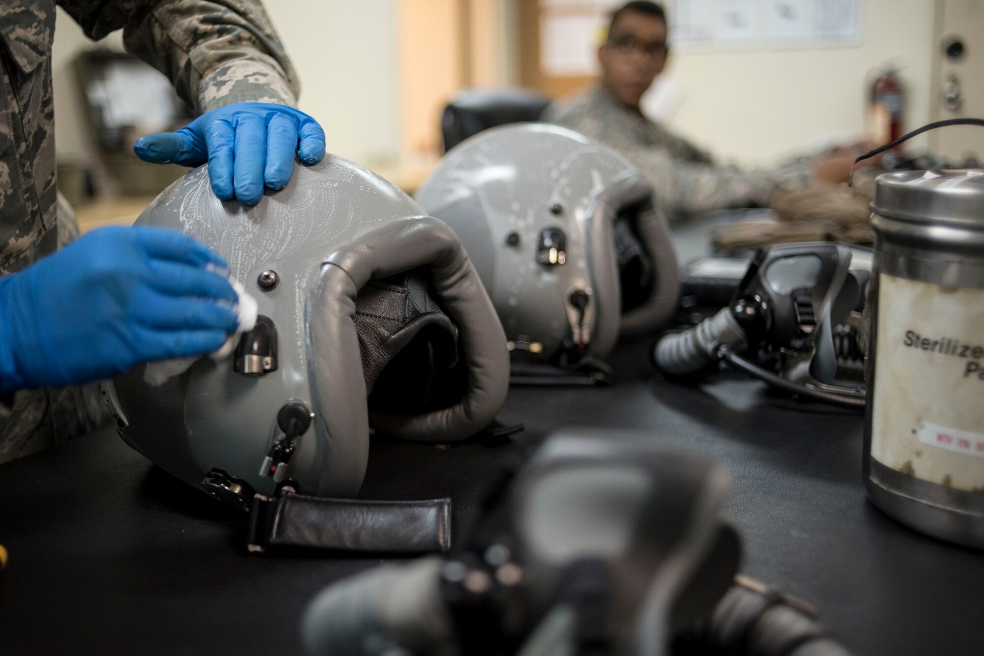 U.S. Air Force Airman 1st Class Denise McCarthy, 18th Operations Support Squadron aircrew flight equipment technician assigned to the 44th Fighter Squadron, cleans a flight helmet April 18, 2017, at Kadena Air Base, Japan. Helmets and other equipment are routinely inspected and repaired to meet all safety specifications. (U.S. Air Force photo by Senior Airman John Linzmeier)