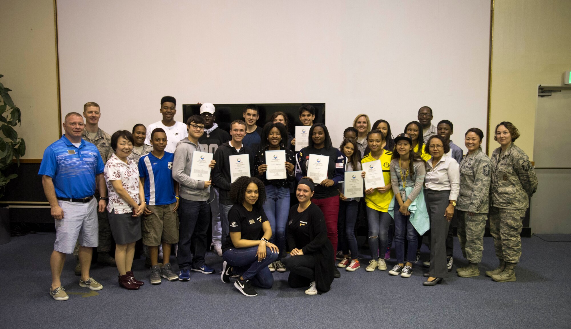 Members of the Keystone Club and Top 3 Okinawa Outreach pose for a group photo April 18, 2017, at the 18th Force Support Squadron Teen and Youth Sports Center on Kadena Air Base, Japan. An appreciation ceremony was held to recognize members of the club for their ongoing contributions to the local community. (U.S. Air Force photo by Senior Airman John Linzmeier)
