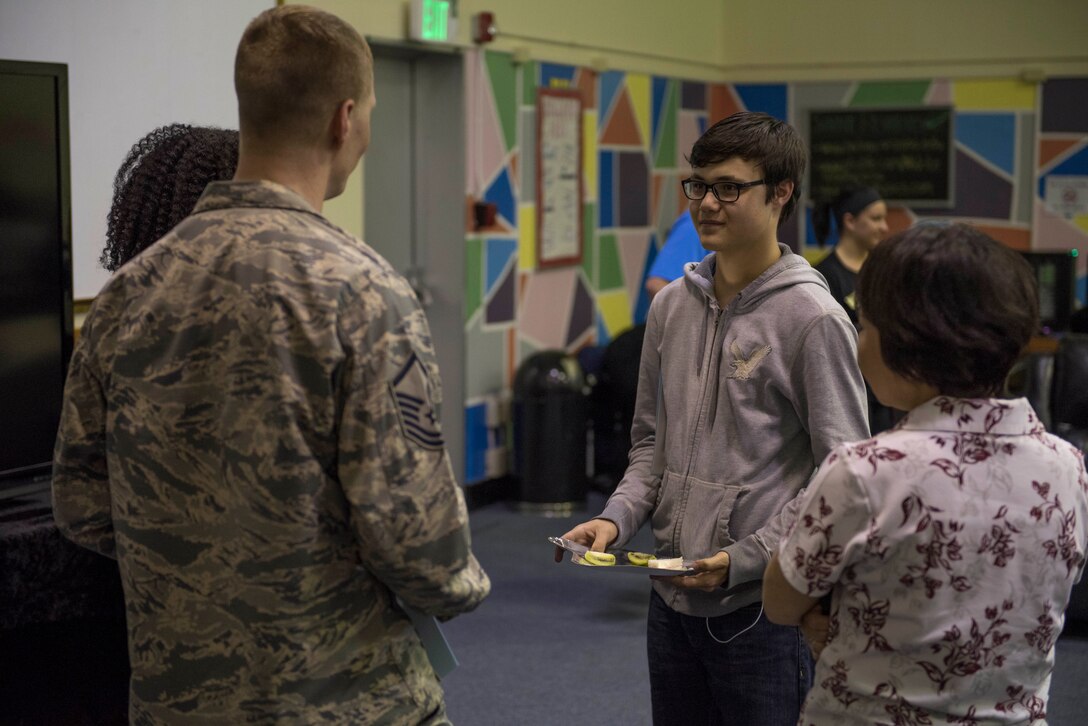 Members of the Keystone Club and Top 3 Okinawa Outreach discuss their progress in making an impact within their community 18, 2017, at the 18th Force Support Squadron Teen and Youth Sports Center on Kadena Air Base, Japan. Each club member was presented with a letter of appreciation from a representative as a token of thanks for their involvement with community service and outreach. (U.S. Air Force photo by Senior Airman John Linzmeier)