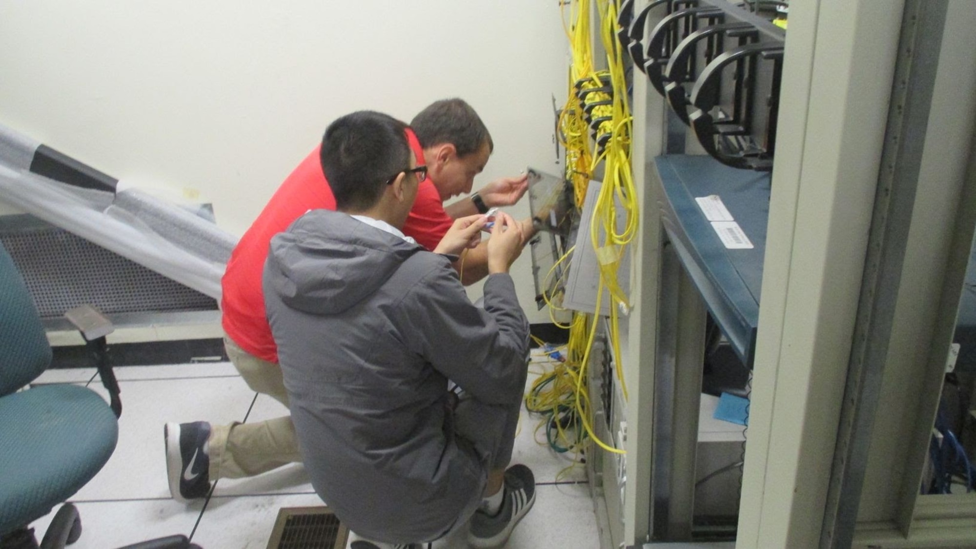 Members of the 38th Cyberspace Engineering Installation Group work on a core node March 28, 2017, at Kadena Air Base, Japan. The 38th CEIG spent more than a month helping the 18th Communications Squadron reduce the overall number of routers on Kadena. This reduction will not only save the Air Force more than $750,000 in maintenance costs each year, it will save 18th CS Airmen more than 100 man hours annually. (Courtesy photo)