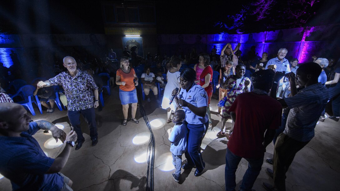 Representatives from the U.S. Embassy and local residents dance during the USAFE Band, Touch and Go, performance in Ouagadougou, Burkina Faso, April 18, 2017. The band performed a one-hour set of Top-40 hits for the local community. (U.S. Air Force photo by Staff Sgt. Jonathan Snyder)