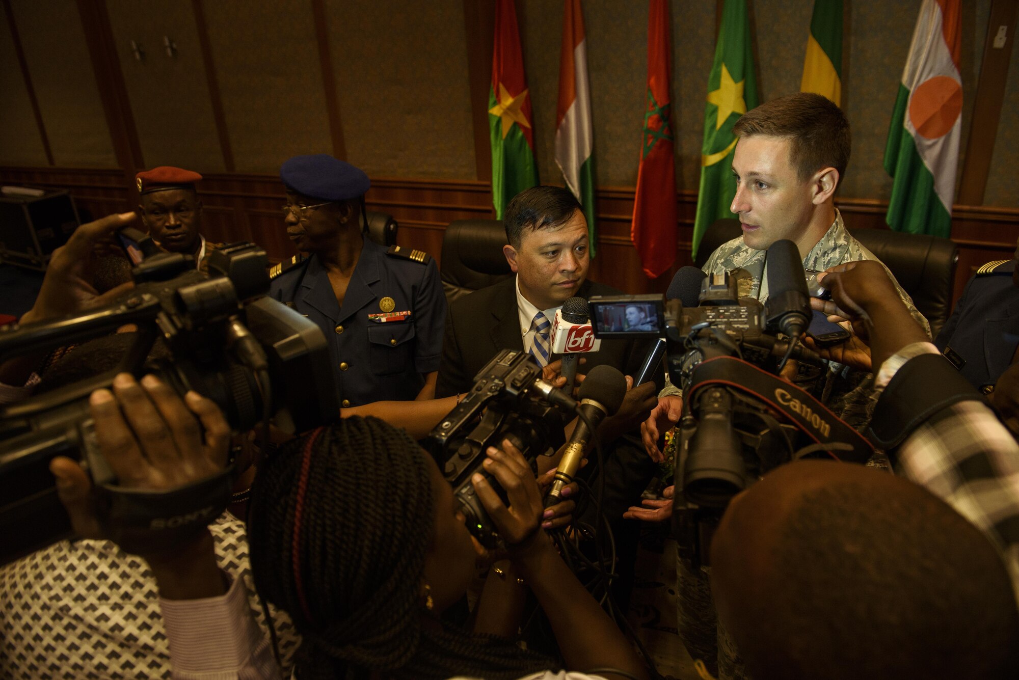 U.S. Air Force Capt. Thomas Bowen, right, translates for Col. Ric Trimillos, center, U.S. Air Forces in Europe-Air Forces Africa division chief of international affairs, during a press conference at opening ceremony of the African Partnership Flight in Ouagadougou, Burkina Faso, April 18, 2017. APF in Burkina Faso hosted participants from Chad, Mali, Mauritania, Niger, Cote d’Ivoire and Morocco to help strengthen relationships and share best practices.
(U.S. Air Force photo by Staff Sgt. Jonathan Snyder)
