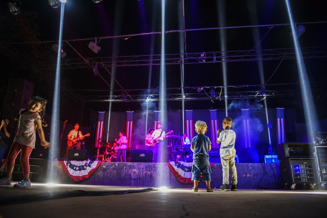 Local children listen to the USAFE Band, Touch and Go, during their performance in the community hosted by the U.S. Embassy in Ouagadougou, Burkina Faso, April 18, 2017. The band performed a one-hour set of Top-40 hits for the local community. (U.S. Air Force photo by Staff Sgt. Jonathan Snyder)