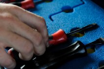 U.S. Air Force Airman 1st Class Locke Williams, 44th Aircraft Maintenance Unit crew chief, takes a screw driver out of a tool box April 19, 2017, at Kadena Air Base, Japan. When performing maintenance on aircraft such as the F-15 Eagle, proper placement of tools is necessary for fast retrieval and use. (U.S. Air Force photo by Senior Airman Lynette M. Rolen)