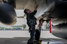 U.S. Air Force 1st Lt. Austin Hurley, 44th Fighter Squadron pilot, performs pre-flight checks on an F-15 Eagle April 19, 2017, at Kadena Air Base, Japan. Pilots inspect their aircraft to make sure it will be safe to operate and carry out the mission. (U.S. Air Force photo by Senior Airman Lynette M. Rolen)
