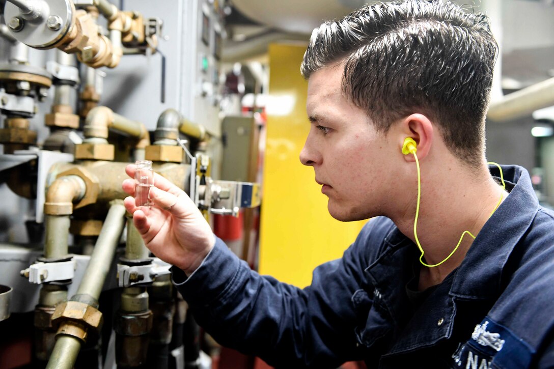 Navy Seaman Nicolas Higgins checks a sample of water from a potable water tank during a routine water quality check aboard the destroyer USS Wayne E. Meyer in the South China Sea, April 10, 2017. Higgins is a machinery repairman fireman. Navy photo by Petty Officer 3rd Class Kelsey L. Adams