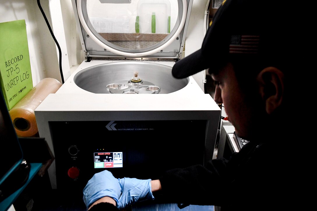 Navy Petty Officer 3rd Class Elias Arreola puts a fuel sample into a centrifuge during a routine fuel quality check aboard the USS Wayne E. Meyer in the South China Sea, April 11, 2017. Arreola is a gas turbine system technician. Navy photo by Petty Officer 3rd Class Kelsey L. Adams