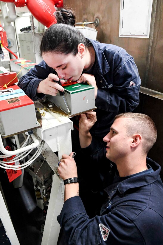 Navy Seamen Marcia Ruiz, above, and Christopher Hauerrberg conduct an electrical maintenance check aboard the USS Wayne E. Meyer in the South China Sea, April 14, 2017. Ruiz and Hauerrberg are damage control firemen. Navy photo by Petty Officer 3rd Class Kelsey L. Adams