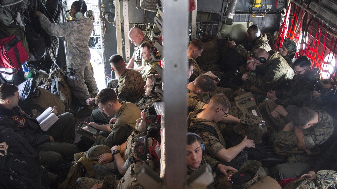 U.S. Marines with Marine Attack Squadron 311 travel aboard a C-130 Hercules during an exercise to Kunsan Air Base, Republic of Korea, from Marine Corps Air Station Iwakuni, Japan, April 12, 2017. VMA 311 is participating in Exercise MAX THUNDER 17, an operational readiness exercise built to promote interoperability between U.S. and ROK forces. This annual exercise helps to promote stability in the Asia-Pacific region.