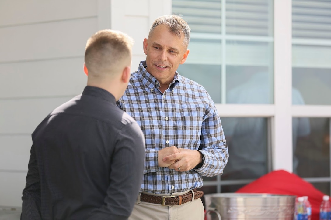 Cpl. Harry Willard Jr., right, speaks to Brig. Gen. Matthew Glavy during a gathering for an award acceptance at Marine Corps Air Station Cherry Point NC, March 22, 2017. Glavy hosted the gathering to present the members of the 2nd Marine Aircraft Band with The Colonel George S. Howard Citation of Musical Excellence for Military Concert Bands, Colonel George S. Howard Citation of Musical Excellence for Military Concert Bands and the Live Performance of the Year Award. The 2nd MAW band holds a reputation of professional excellence as they dedicate countless hours to both music and the community. Glavy is the commanding general of 2nd MAW and Willard is a guitarist with the band. (U.S. Marine Corps photo by Sgt. N.W. Huertas/ Released) 
