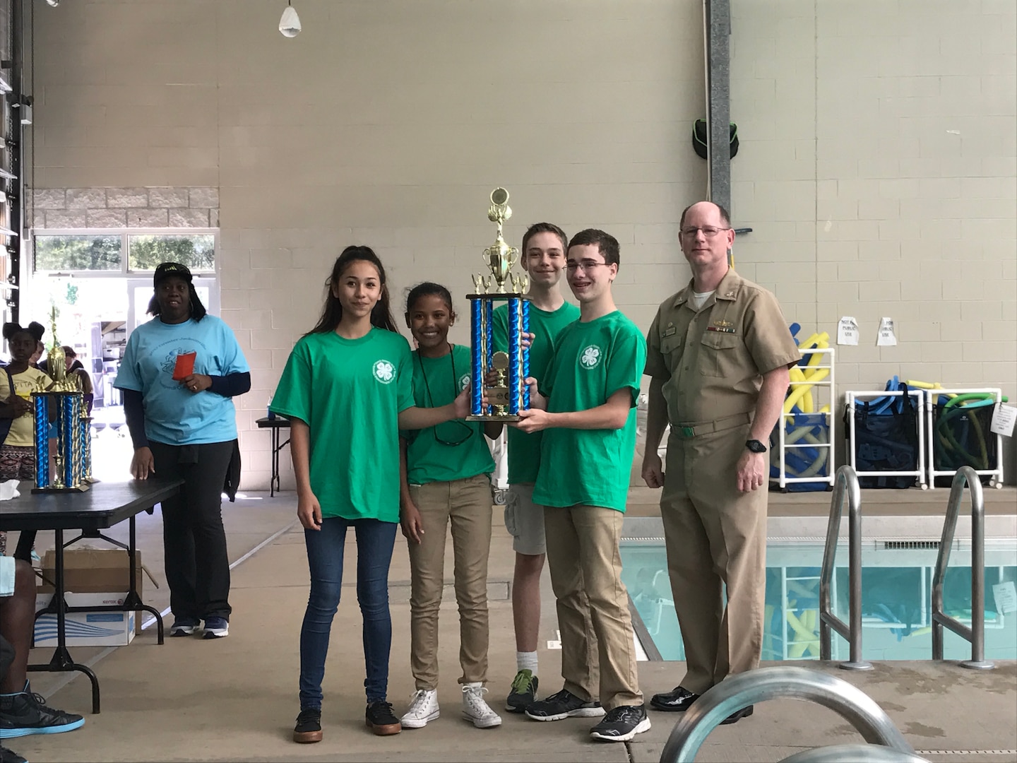 SERMC Commanding Officer, Capt. Dave Gombas, (right) stands with the winning middle school team from Mayport Coastal Sciences Middle School. Students participating in SeaPerch learn important engineering and design skills while exploring naval architecture and ocean engineering principles.