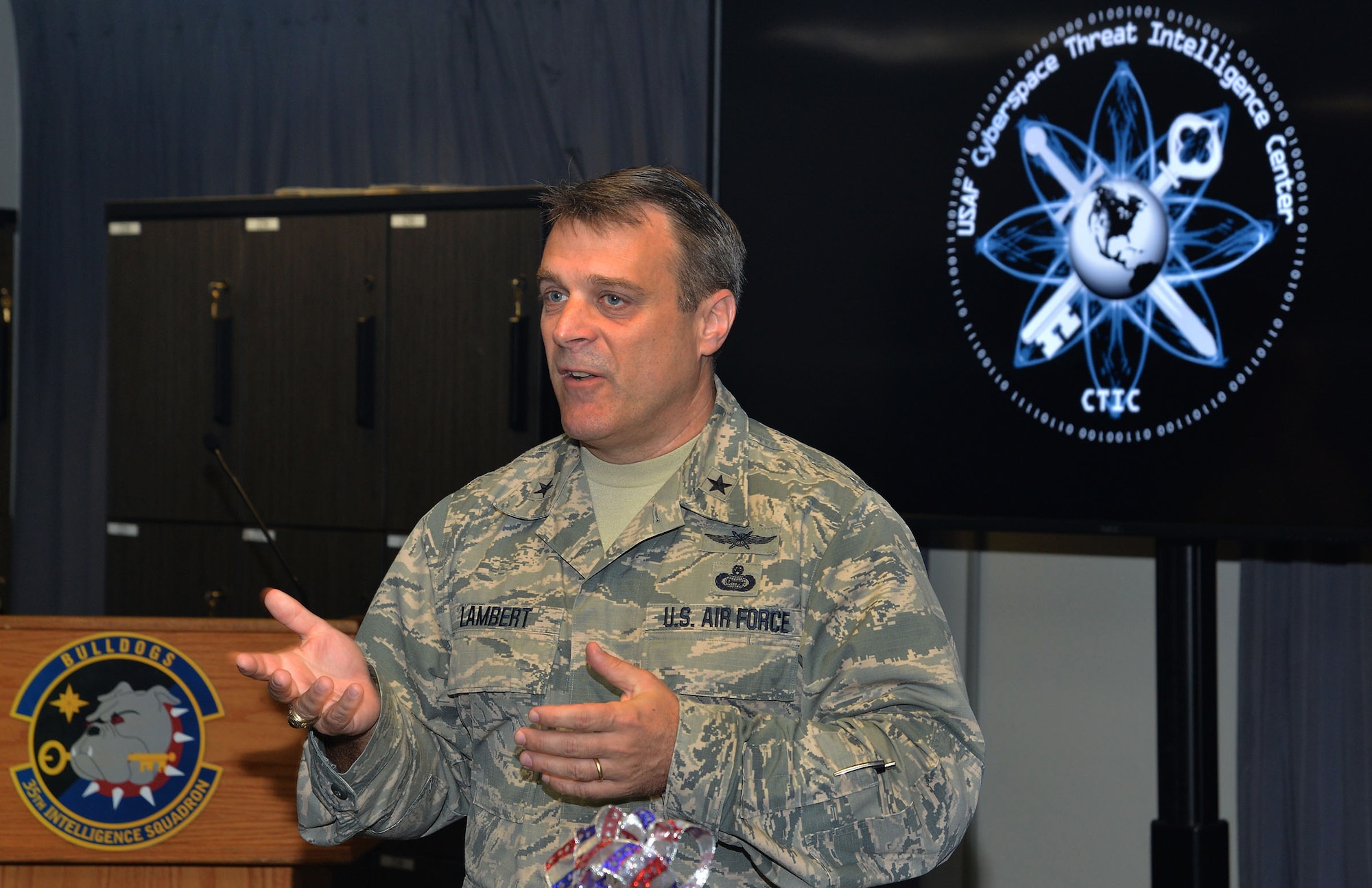 Brig. Gen. Peter Lambert, director of intelligence, Headquarters Air Combat Command, talks to guests about the Cyberspace Threat Intelligence Center during the ribbon cutting ceremony Apr. 10. (U.S. Air Force photo by Lori Bultman)