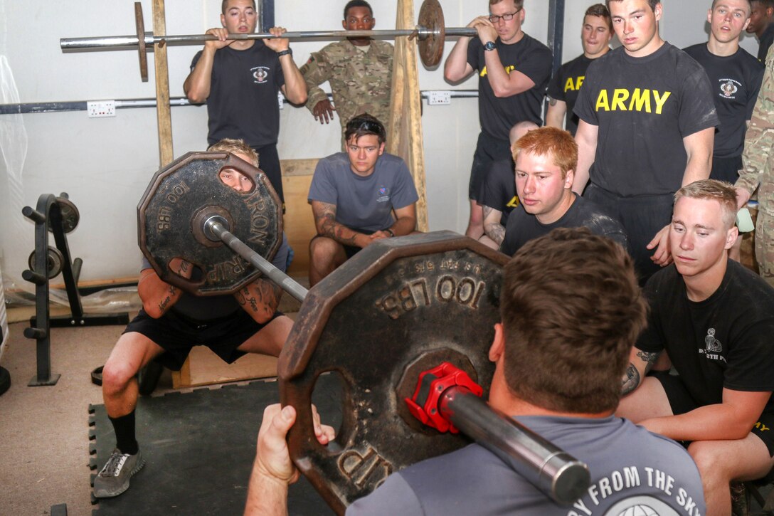 Soldiers participate in a partner-squat event during a strongman competition held at a tactical assembly area near Bakhira, Iraq, April 12, 2017. Army photo by Staff Sgt. Jason Hull