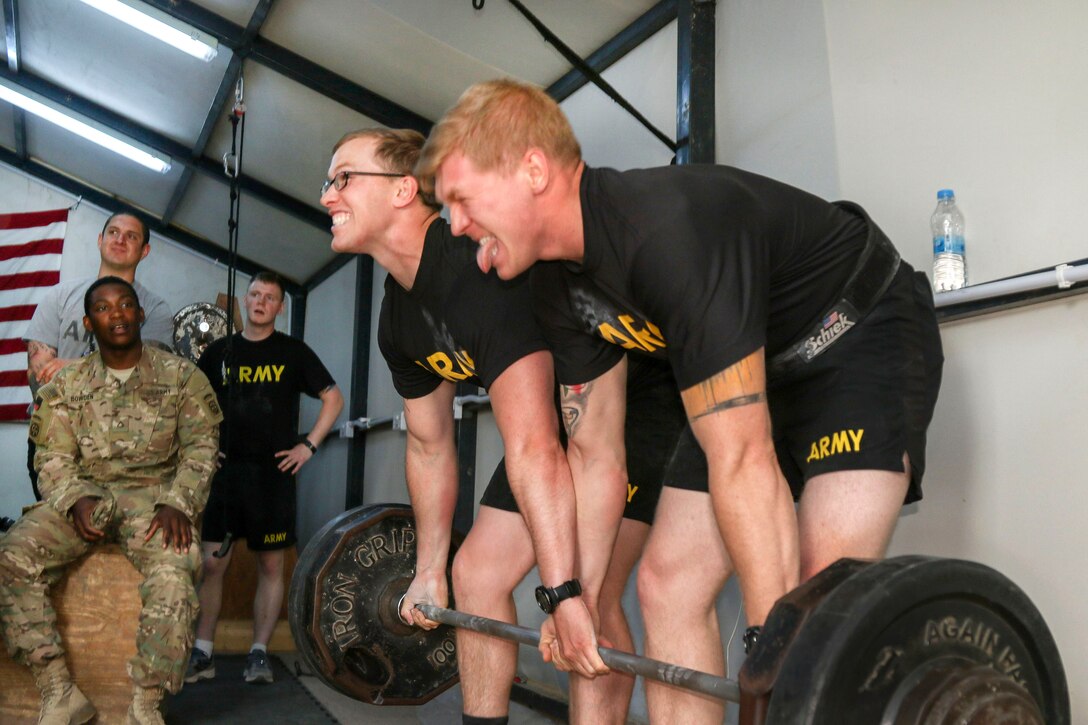 Army Staff Sgt.s Ryan Konjevich, right, and Tyler Price compete in the partner deadlift event during a strongman competition held at a tactical assembly area near Bakhira, Iraq, April 12, 2017. Konjevich and Price are assigned to the 82nd Airborne Division’s 2nd Brigade Combat Team. Army photo by Staff Sgt. Jason Hull
