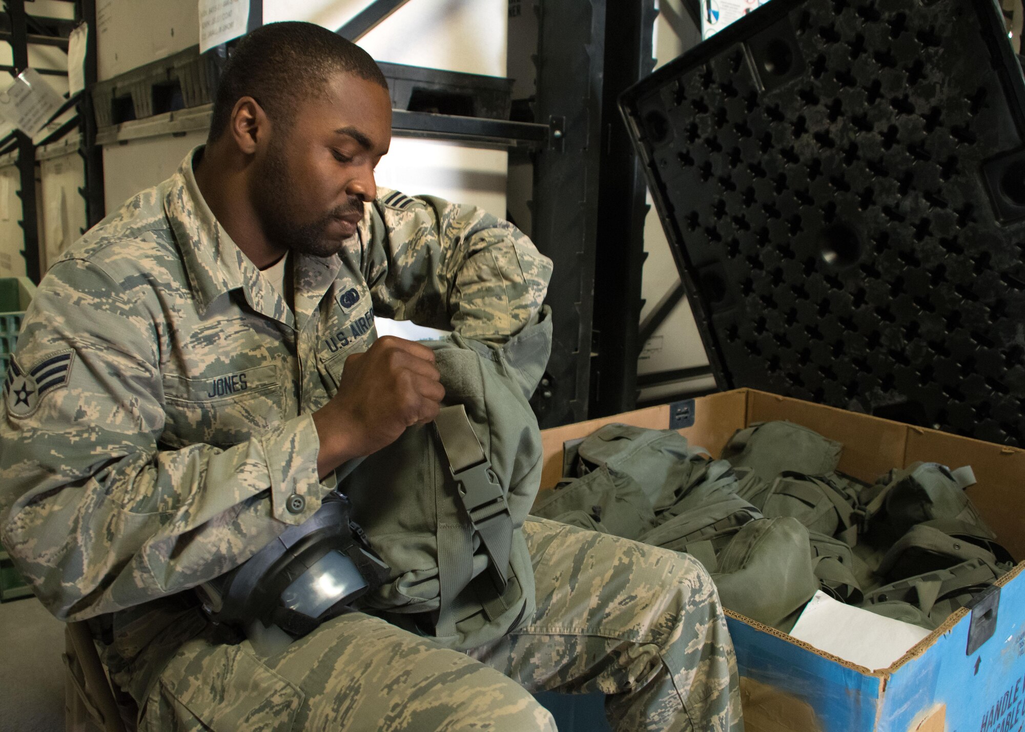 Senior Airman Antonio Jones, a 386th Expeditionary Logistics Readiness Squadron mobility technician, inventories gas masks at an undisclosed location in Southwest Asia April 7, 2017. Jones is part of the 386th ELRS expeditionary theater distribution center and is responsible for inspecting equipment and then issuing it to forward deployers. (U.S. Air Force photo/Staff Sgt. Andrew Park)