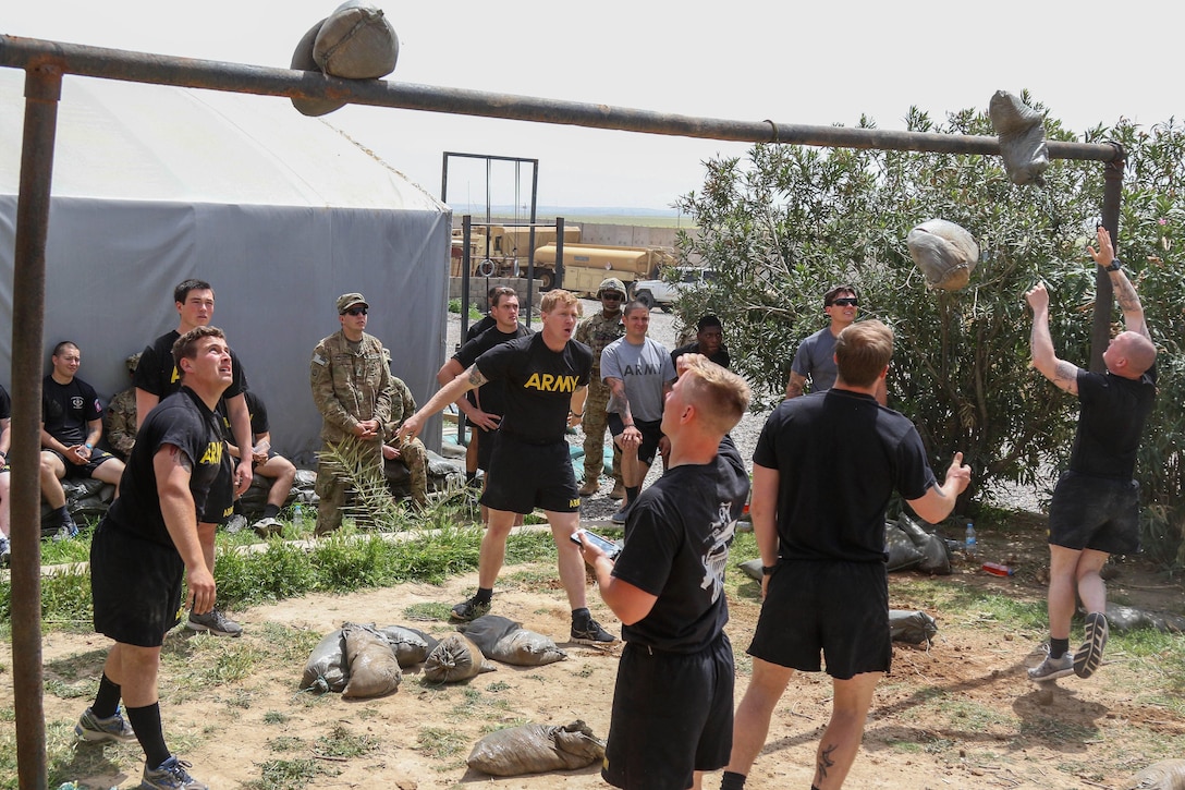 Soldiers compete in a sandbag toss relay during the strongman competition held at a tactical assembly area near Bakhira, Iraq, April 12, 2017. Army photo by Staff Sgt. Jason Hull