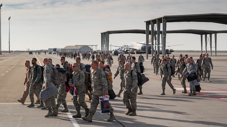 A mass of airmen returning from a deployment to Southwest Asia walk the flightline at Mountain Home Air Force Base, Idaho, April 12, 2017. After several hours on a passenger aircraft, the airmen refused the buses that had been sent out to pick them up, preferring instead to walk the short distance to their awaiting family members who were assembled in a nearby hangar. (U.S. Air Force photo by Staff Sgt. Samuel Morse)