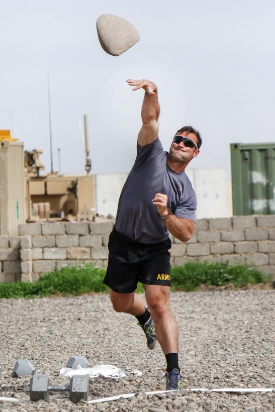 Army Sgt. Charles Ewing heaves a rock during a strongman competition held at a tactical assembly area near Bakhira, Iraq, April 12, 2017. Ewing is assigned to the 82nd Airborne Division’s 2nd Brigade Combat Team. Army photo by Staff Sgt. Jason Hull