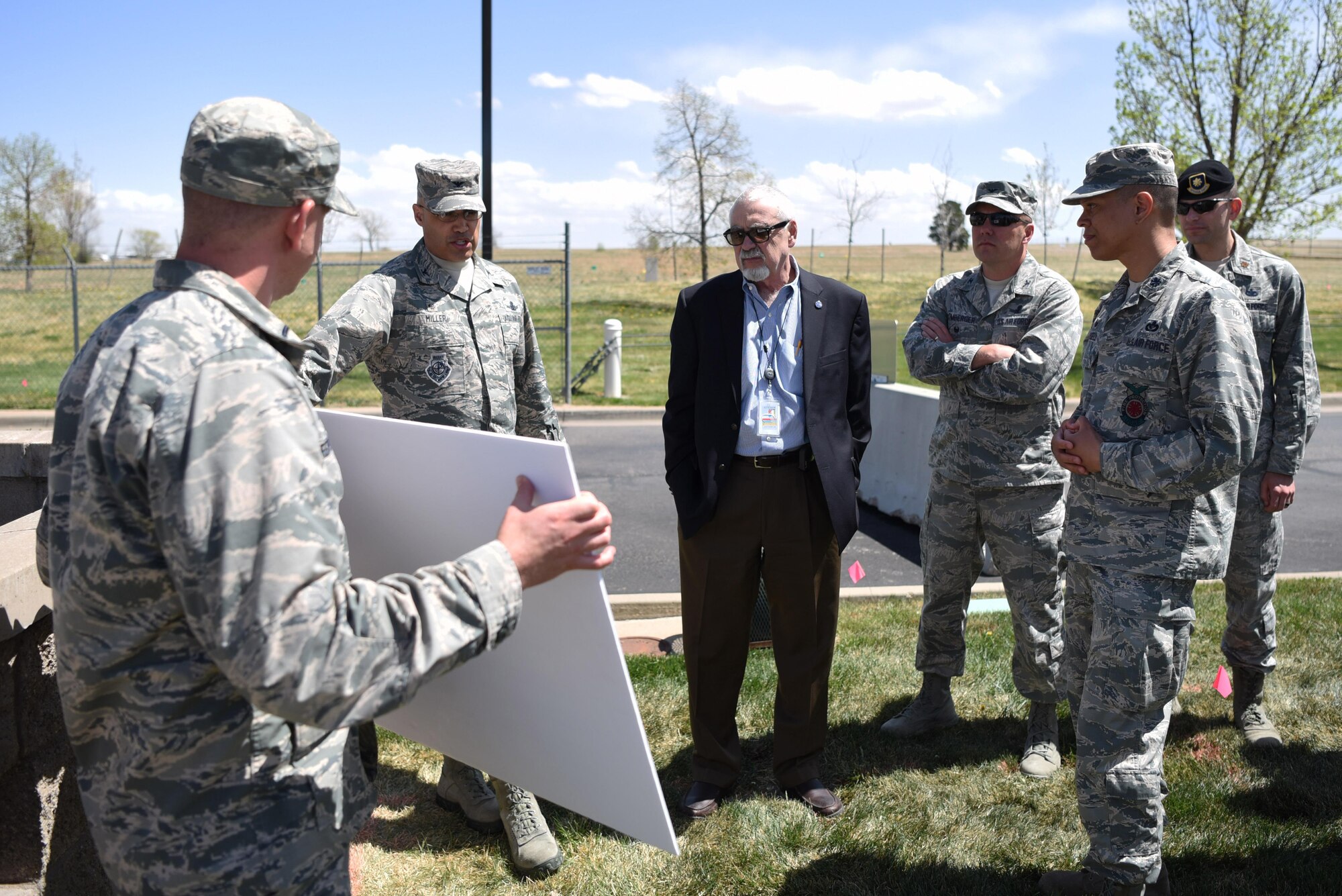 Team Buckley’s leadership team discusses future construction plans for the 6th Avenue Gate with George “Skip” Noe, Aurora city manager, April 19, 2017, on Buckley Air Force Base, Colo. When completed, the update to this gate will improve city traffic by redirecting commercial vehicles to a more accessible route. (U.S. Air Force photo by Airman First Class Holden S. Faul/ Released)