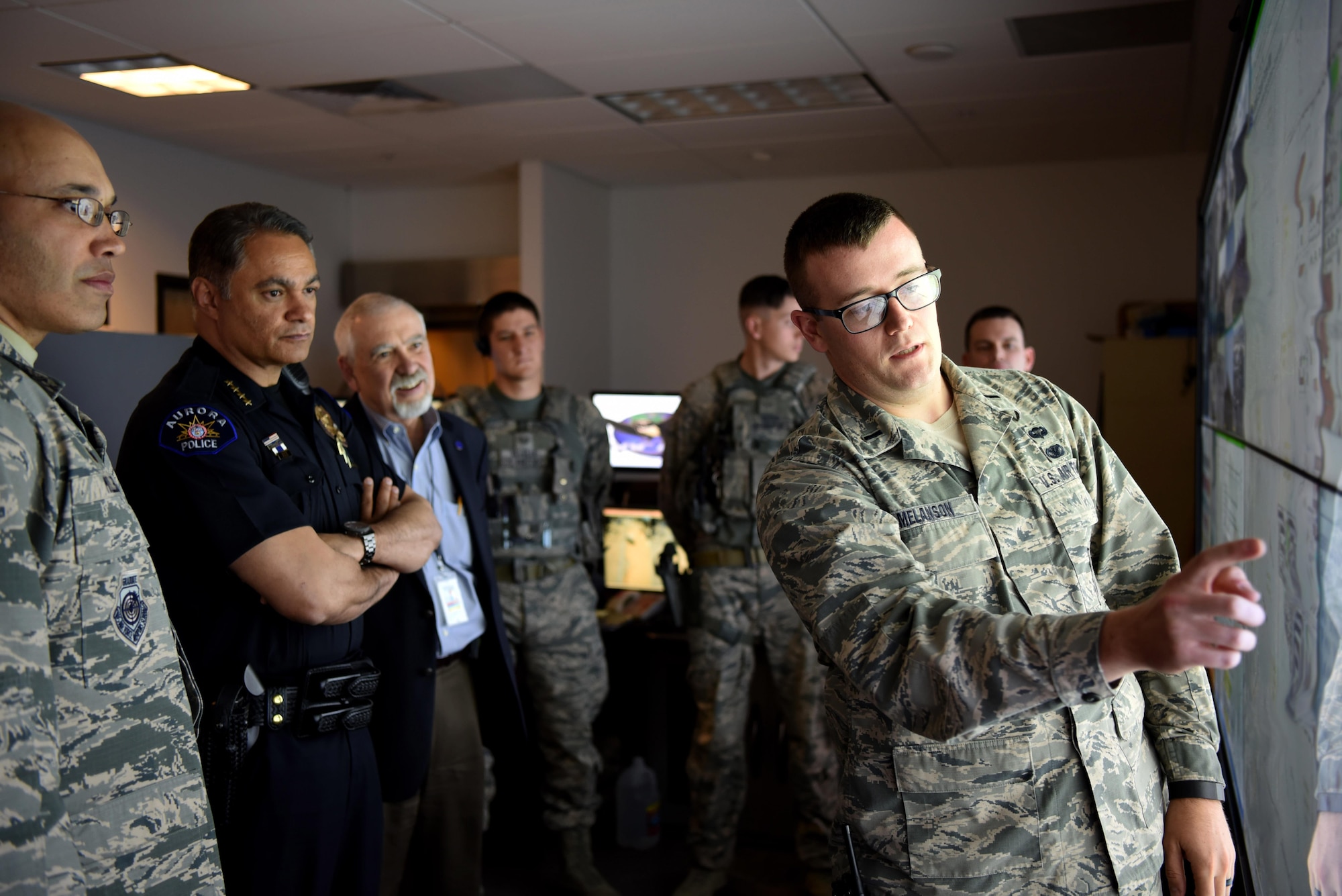 1st Lt. Conor Melanson, 460th Security Forces Squadron operations officer, breaks down base defense capabilities to Nicholas Metz, Aurora chief of police, and George “Skip” Now, Aurora city manager, April 19, 2017, on Buckley Air Force Base, Colo. By showing Buckley AFB’s capabilities, 460th SFS is able to show the types of scenarios which they might need assistance from local authorities. (U.S. Air Force photo by Airman First Class Holden. S. Faul/Released)