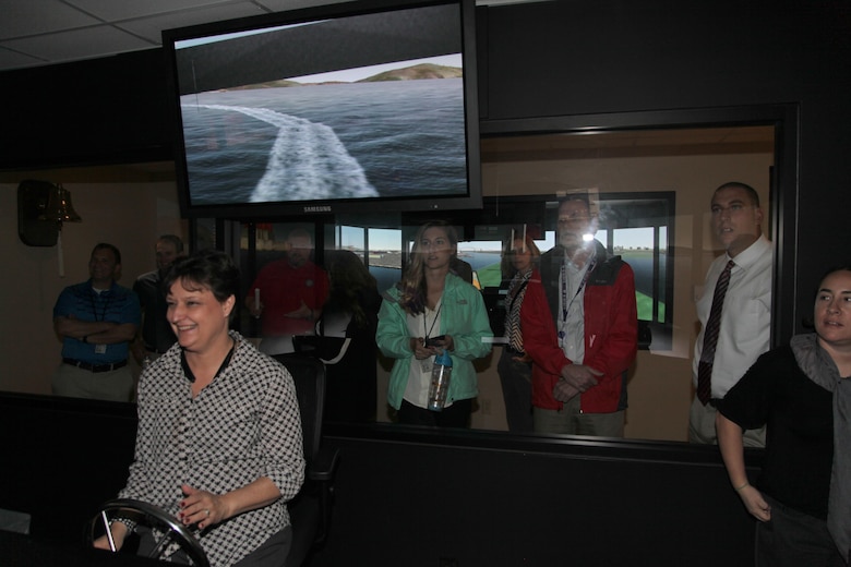 During their welcome week tour, ERDC University participants are all smiles at the Coastal and Hydraulics Laboratory’s ship simulator.