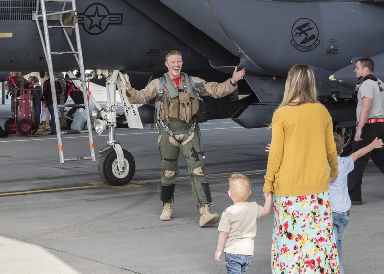 An F-15E Strike Eagle crew member greets his family for the first time in six months at Mountain Home Air Force Base, Idaho, April 8, 2017. Approximately 20 jets and 500 airmen returned that week after deploying for to Southwest Asia in support of Operation Inherent Resolve. (U.S. Air Force photo by Airman Jeremy D. Wolff)