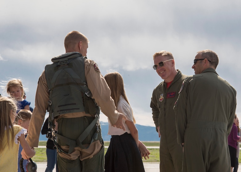 Col. Brian McCarthy (center-right), 366th Operations Group commander, welcomes home returning airmen at Mountain Home Air Force Base, Idaho, April 8, 2017. The airmen returned from a six-month deployment to Southwest Asia in support of Operation Inherent Resolve. (U.S. Air Force photo by Airman Jeremy D. Wolff)