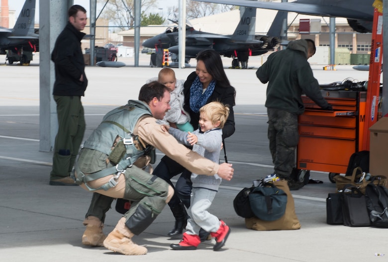 A family embraces their service member after being away for six months, April 10, 2017, at Mountain Home Air Force Base, Idaho. More than 5,000 munitions were dropped on ISIS targets in support of Air Forces Central Command. (U.S. Air Force photo by Senior Airman Malissa Lott/Released)