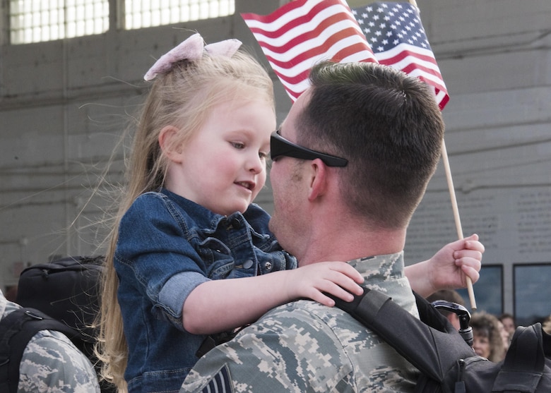 A little girl greets her dad as he returns after a six month deployment, April 12, 2017, at Mountain Home Air Force Base, Idaho. Airmen and aircraft were deployed to Southwest Asia in support of Operation Inherent Resolve. (U.S. Air Force photo by Airman Alaysia Berry/Released)