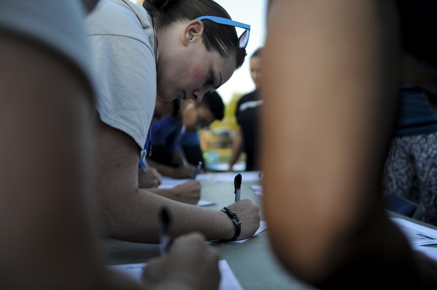 Tech. Sgt. Pamela Mericle, a cyber transport craftsman with the 11th Special Operations Intelligence Squadron, signs up for a 5-kilometer  run at Hurlburt Field, Fla., April 19, 2017. The 5k was held in observance of Sexual Assault Prevention and Awareness Month. (U.S. Air Force photo by Airman 1st Class Dennis Spain)