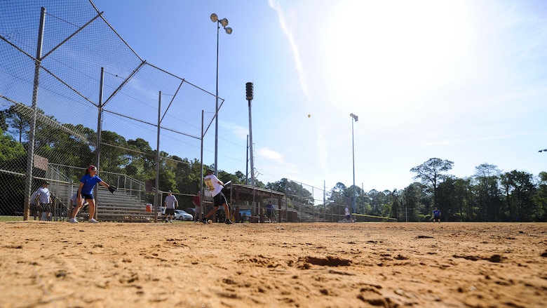 Joshua Reynolds, a third baseman with the Hurlburt Field Fire and Emergency Services softball team, hits the softball at Hurlburt Field, Fla., April 14, 2017. Reynolds participated in Battle of the Badges – a softball tournament in which police officers and firefighters from Okaloosa County and Hurlburt Field compete to be known as the 2017 Battle of the Badges champions. (U.S. Air Force photo by Airman 1st Class Dennis Spain)