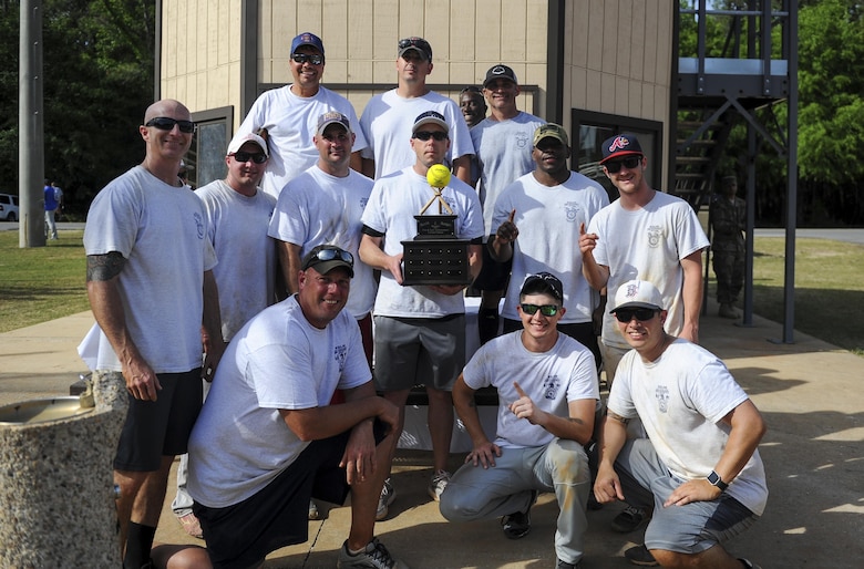 Airmen from Eglin Fire Emergency Services stand with the championship trophy after winning the Battle of the Badges softball tournament at Hurlburt Field, Fla., April 14, 2017. Eglin Fire Emergency Services won the Battle of the Badges against the 96th Security Forces Squadron with a score of 10 to 9. (U.S. Air Force photo by Airman 1st Class Isaac O. Guest IV)