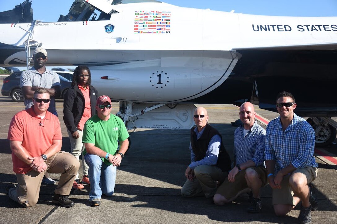Special Agents from Air Force Office of Special Investigations Detachment 405, Maxwell Air Force Base, Ala., pause alongside a U.S. Air Force F-16  flown by the Air Force Thunderbirds aerial demonstration team. The T-Birds performed a dedication flight to Fallen AFOSI Special Agent Chester McBride during the Maxwell Air Show April 8-9. (U.S. Air Force photo/USAF Thunderbirds)     