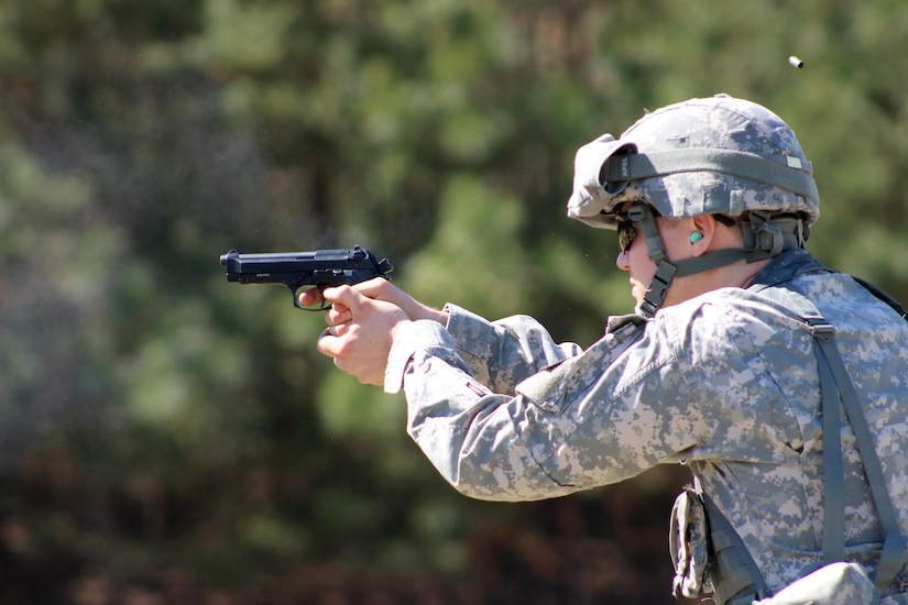 Staff Sgt. Derek Roy, 29, a paralegal NCO from Danbury, Conn., fires an M-9 pistol during the USAR Legal Command Best Warrior Competition at Fort A.P. Hill Virginia.