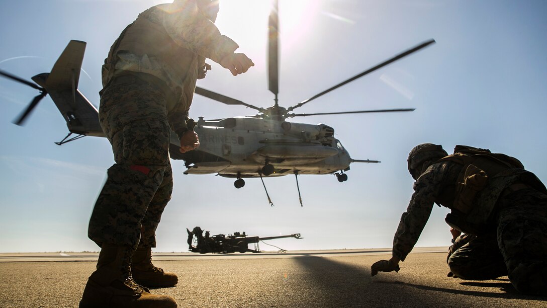 Marines prepare to attach an M777 howitzer to a CH-53E Super Stallion helicopter during integrated slingload training at Marine Corps Base Camp Pendleton, Calif., April 12, 2017. Marine Corps photo by Cpl. Frank Cordoba