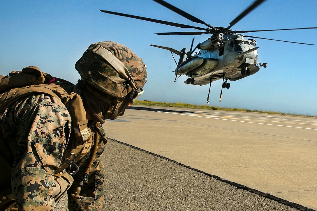 Marine Corps Lance Cpl. Kieran Hayes waits for a CH-53E Super Stallion helicopter to get in position to conduct integrated slingload training at Marine Corps Base Camp Pendleton, Calif., April 12, 2017. Hayes is a landing support specialist assigned to Combat Logistics Battalion 15, 15th Marine Expeditionary Unit. Marine Corps photo by Cpl. Frank Cordoba