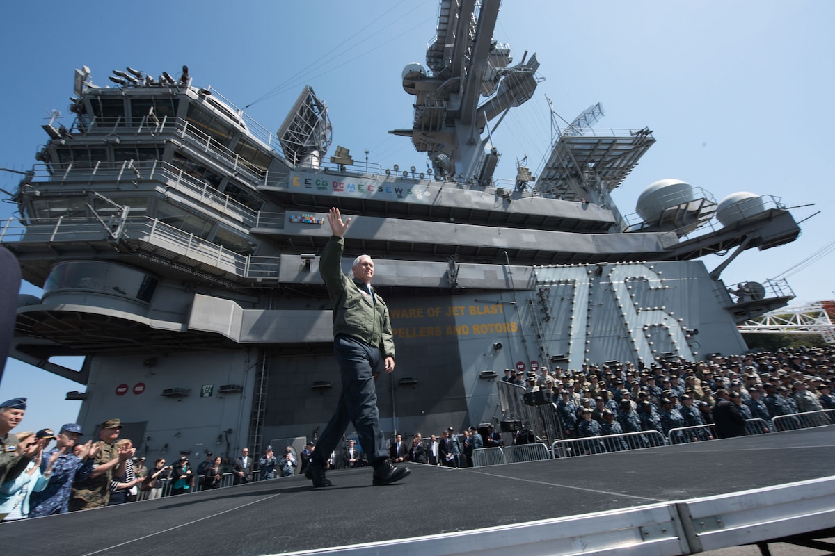 The U.S. vice president waves to service members on a ship.
