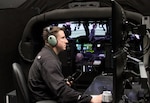 Chief Warrant Officer 2 Travis Vanlengen, an Iowa Army National Guard UH-60M instructor pilot with Company C, 2nd Brigade, 147th Aviation Battalion, of Boone, Iowa, and a certified Black Hawk Aircrew Trainer instructor-operator, monitors a pilot’s flight at the Camp Dodge Joint Maneuver Training Center, in Johnston, Iowa. The instructor-operator’s screens allow him to see the pilot inside the aircraft, as well as watch their flight path on a map, while controlling stress factors, such as inclement weather, enemy fire and mechanical failures. Vanlengen said these safety hazards are possible, both in peacetime and at war, and can be fatal without the proper training. 