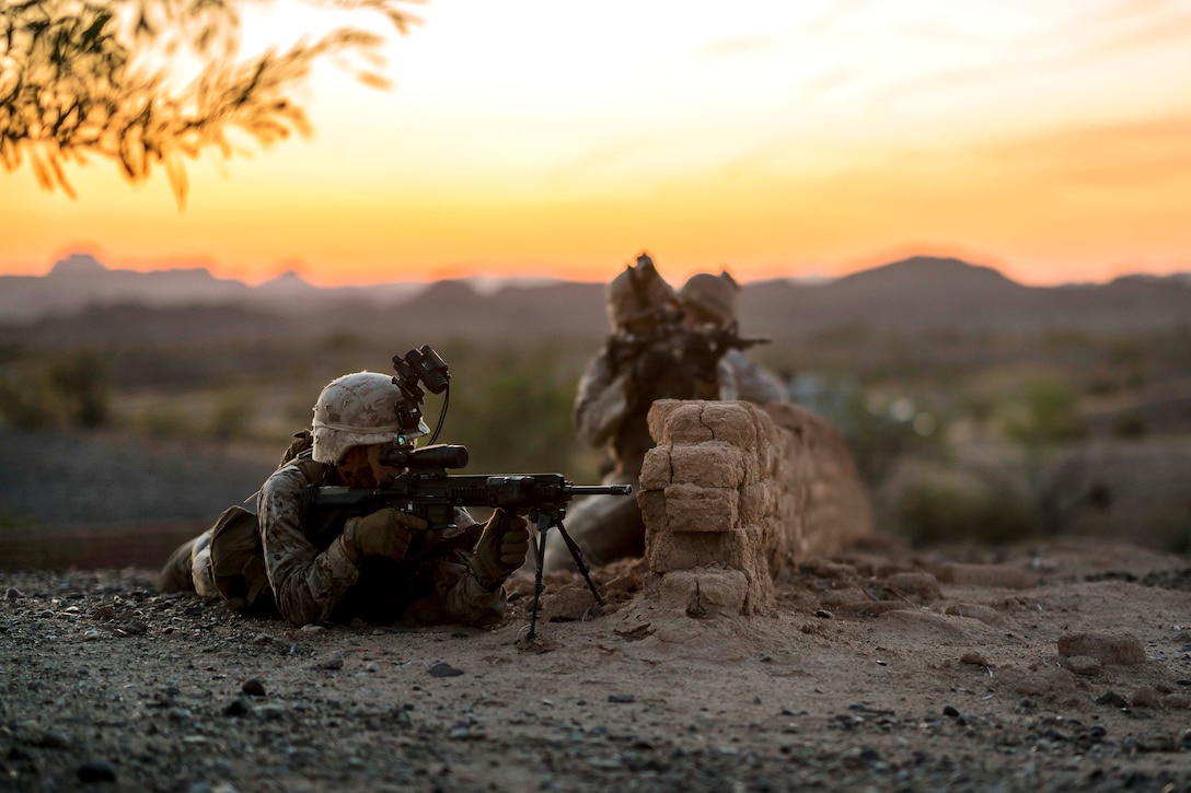 Marines provide security from the cover of a wall during a heavy-Huey raid as part of Weapons and Tactics Instructors course 2-17 at Yuma Proving Grounds, Ariz., April 12, 2017. The Marines are assigned to 2nd Battalion, 6th Marine Regiment. Air Force photo by Tech. Sgt. Chris Hibben