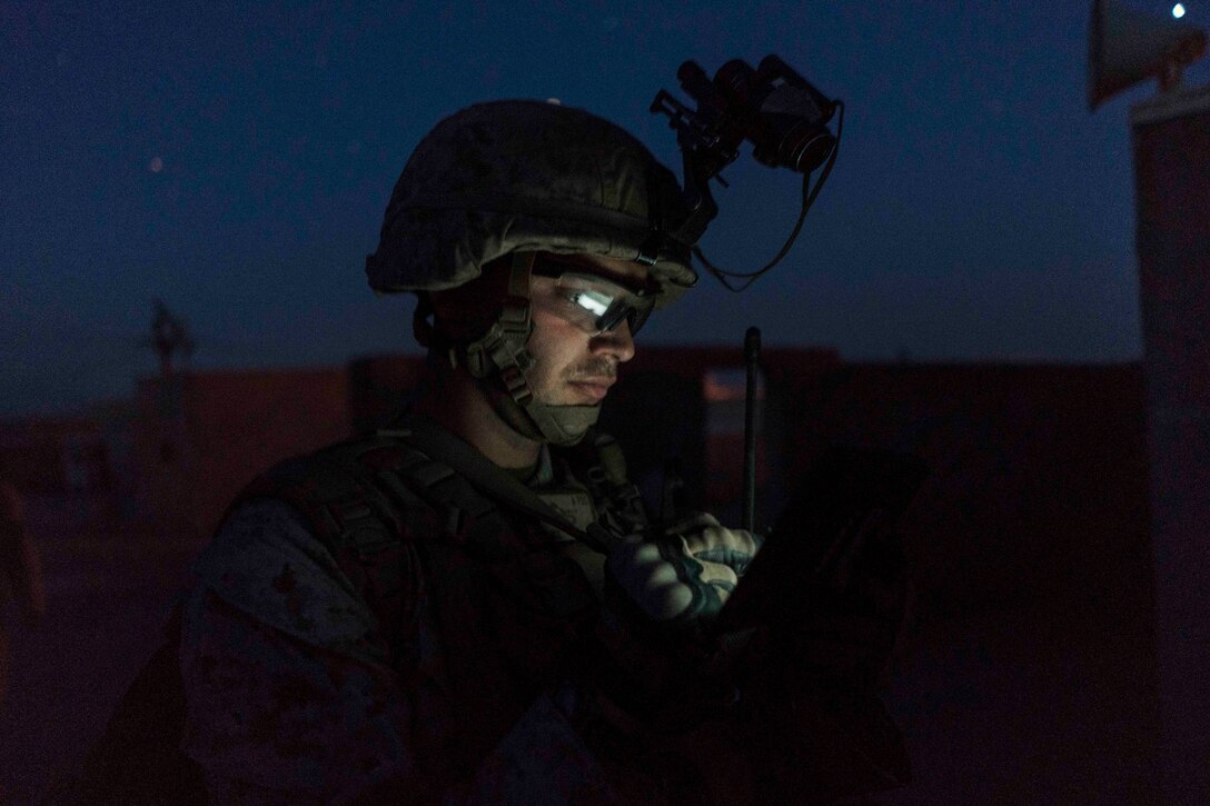 A Marine uses a tablet to determine map coordinates during a heavy-Huey raid as part of Weapons and Tactics Instructors course 2-17 at Yuma Proving Grounds, Ariz., April 12, 2017. Air Force photo by Tech. Sgt. Chris Hibben