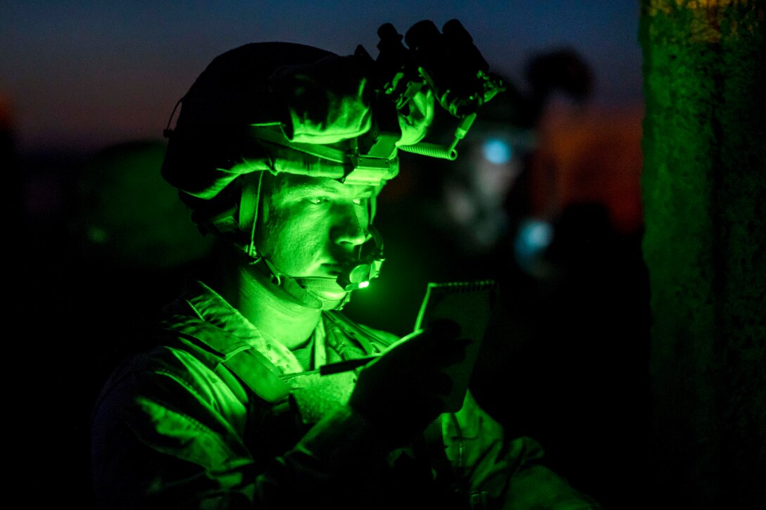 A Marine uses a green light to read his notes during a heavy-Huey raid as part of Weapons and Tactics Instructors course 2-17 at Yuma Proving Grounds, Ariz., April 12, 2017. Air Force photo by Tech. Sgt. Chris Hibben