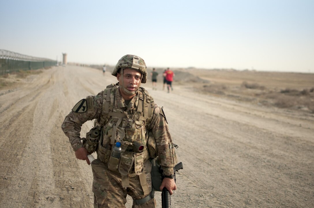 Staff Sgt. Eric Watts, a Soldier with the 1st Cavalry Division Regional Sustainment Support Brigade,  pushes towards the finish line of the 1st Sustainment Command (Theater) Best Warrior Competition 10-mile ruck march at Camp Arifjan, Kuwait April 16th, 2017.
(US Army Photo by Sgt. Christopher Bigelow)