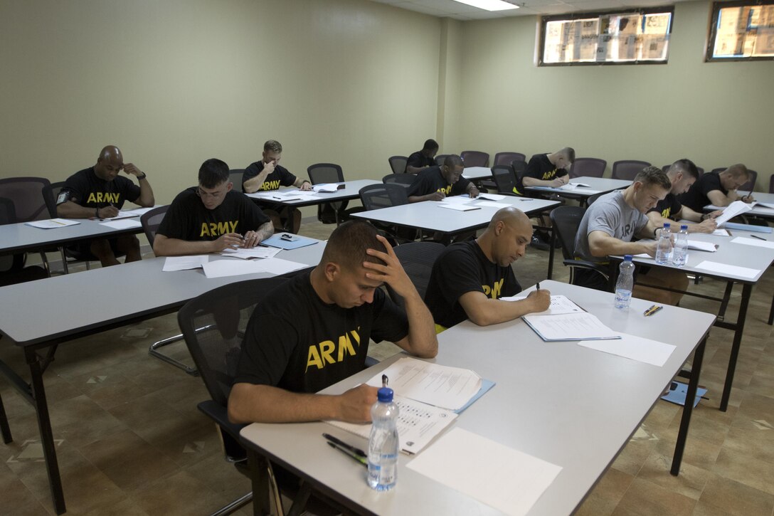 Competitors of the 1st Sustainment Command (Theater) Best Warrior Competition answer questions during a written exam at Camp Arifjan, Kuwait, April 14, 2017. (U.S. Army Photo by Staff Sgt. Dalton Smith)